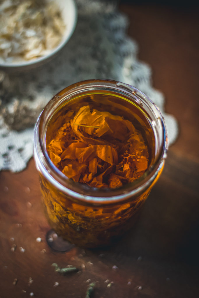 herbal oil steeping in jar close up