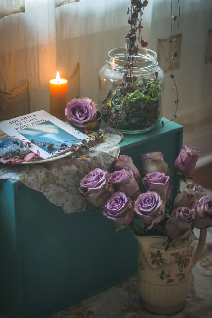 aquarius altar with roses candle and skullcap 