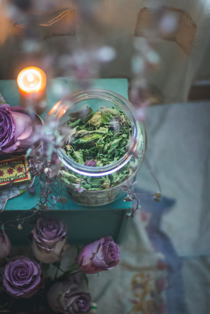 skullcap in jar with candle and rose