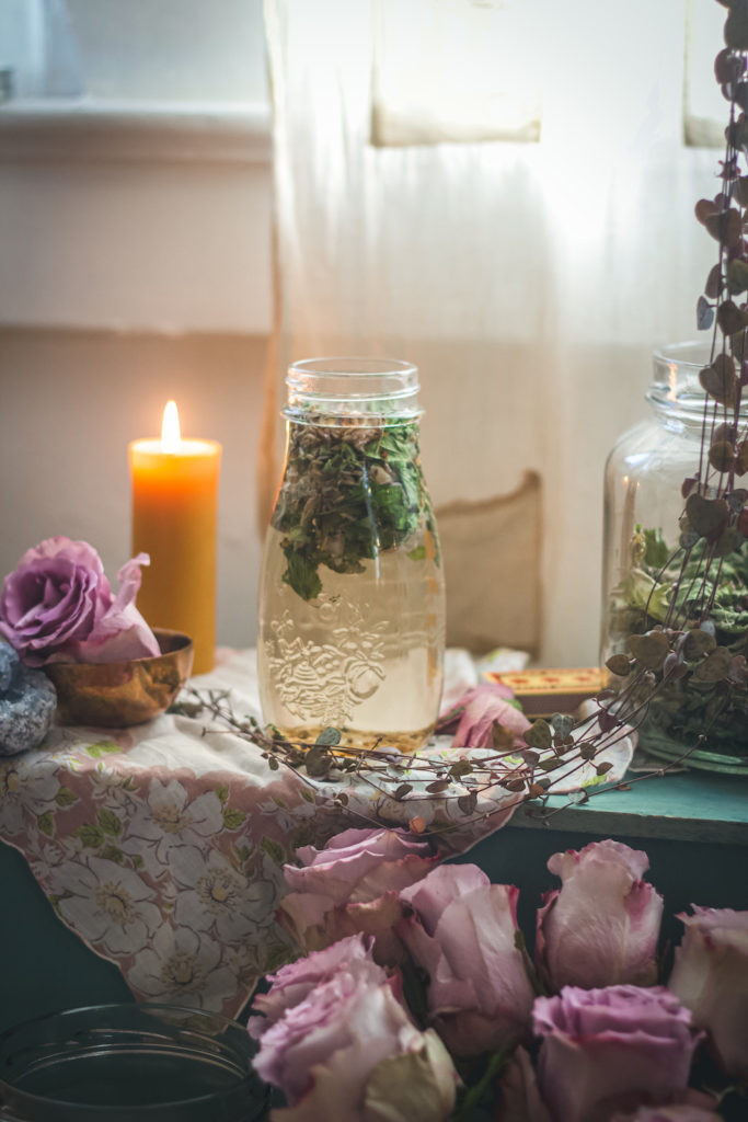 skullcap lavender rose tea in jar with candle