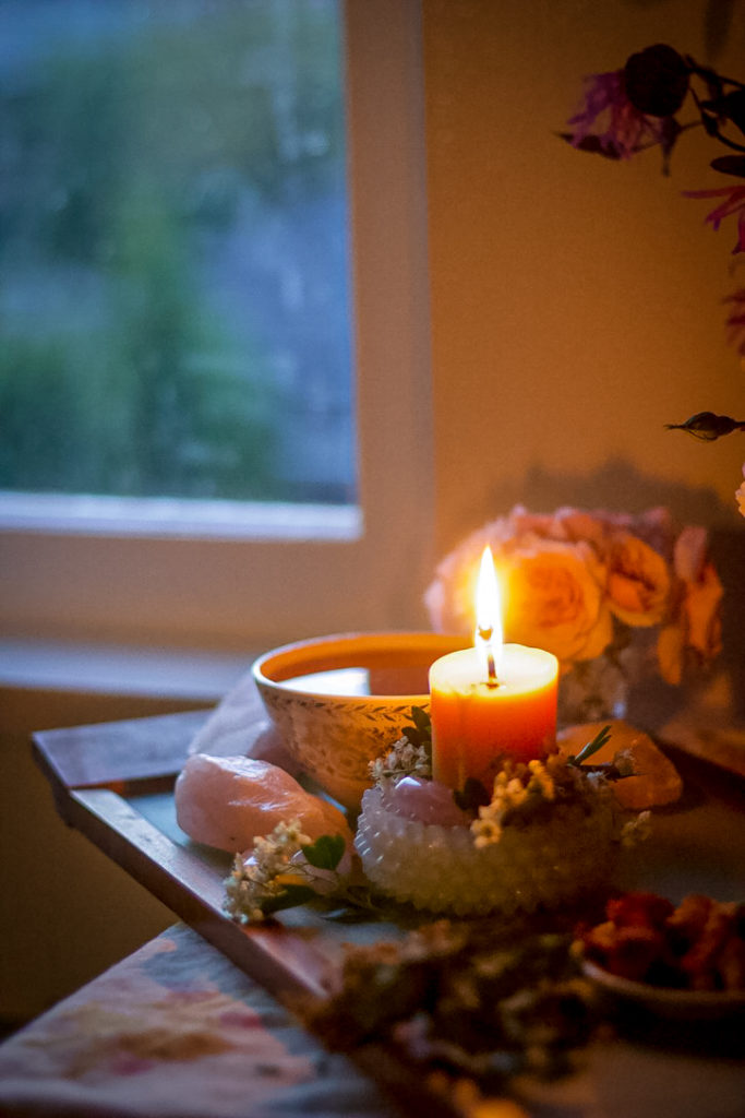 candle and tea cup with window in background