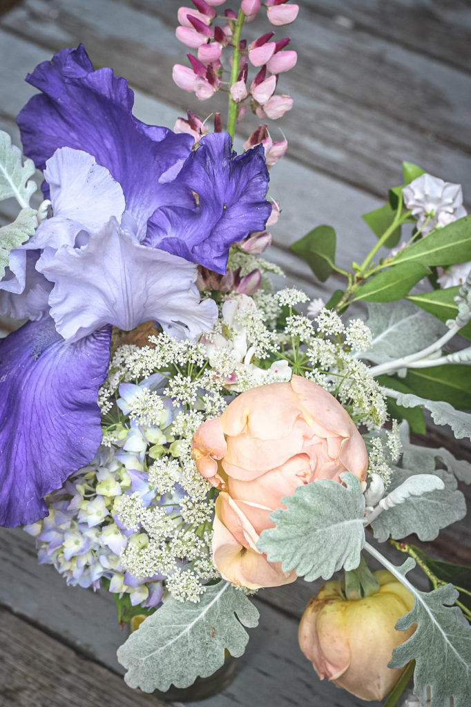 blue iris peach rose arrangement